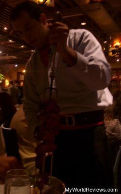 A piece of meat being cut and served