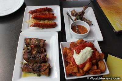 Tapas at La Tasca (From Top Left Clockwise - Chorizo a la Parilla, Brocheta de Cordero, Canelones de Berenjenas, Patatas Bravas)