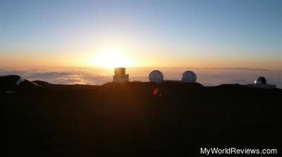The sun setting into the clouds from the summit of Mauna Kea